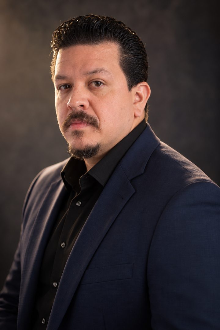 Antonio Cardona in a navy blazer and black shirt, Miami realtor with RE/MAX City Centre Realty